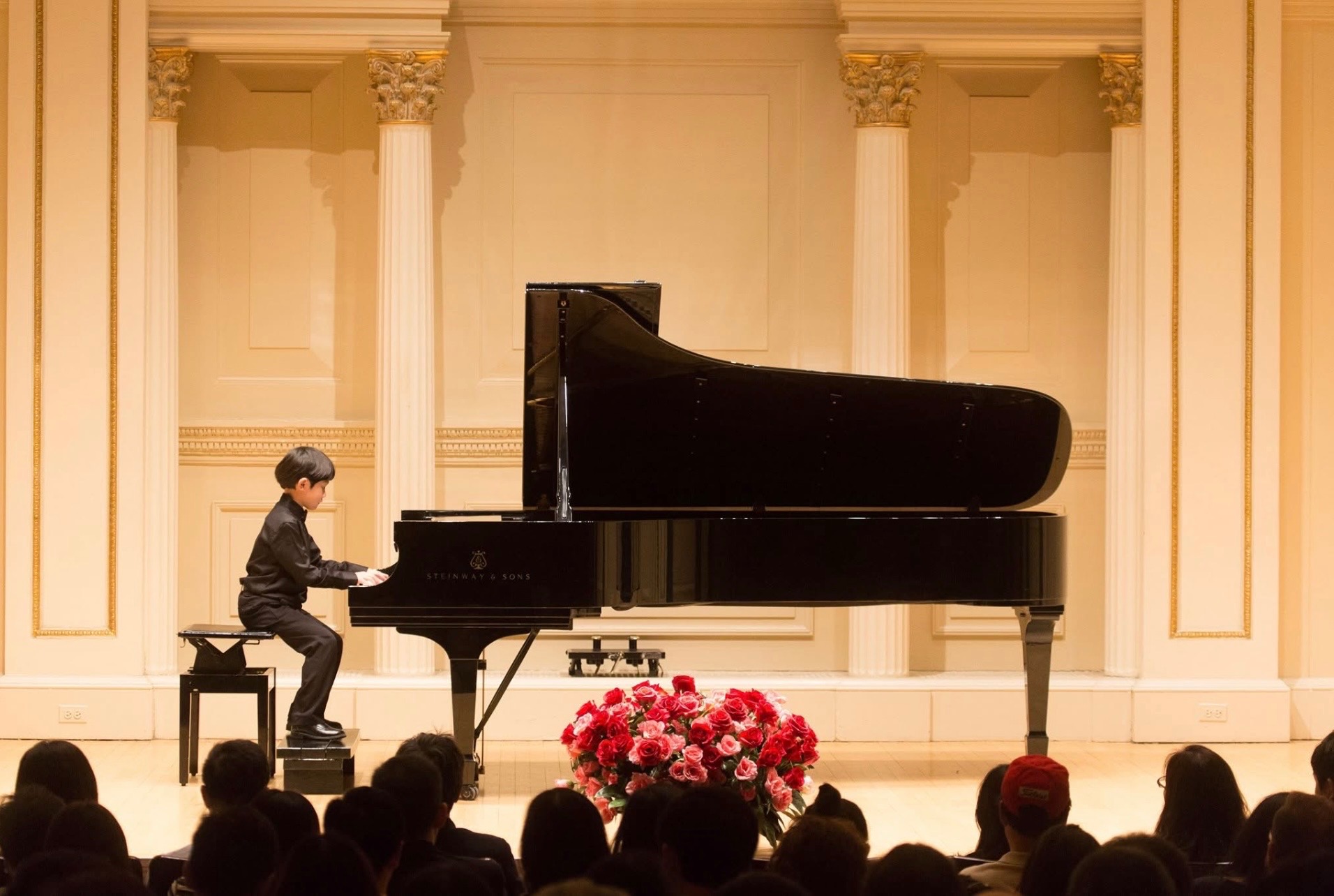A young DJ Wang performing at a grand piano